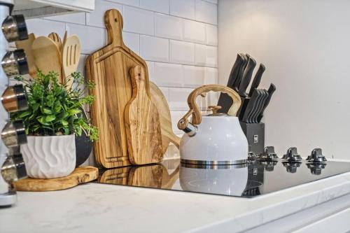 a kitchen counter with wooden cutting boards and a sink at Spacious Ou Hideaway Hot Tub Pool Table in Norman