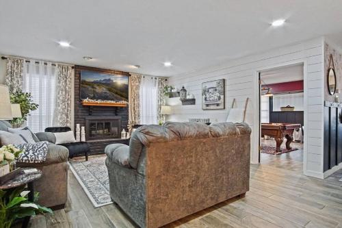 a living room with a couch and a piano at Spacious Ou Hideaway Hot Tub Pool Table in Norman