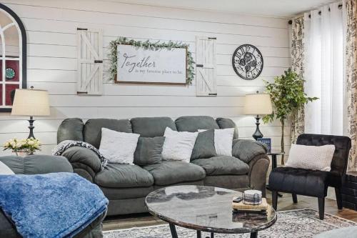a living room with a couch and a table at Spacious Ou Hideaway Hot Tub Pool Table in Norman