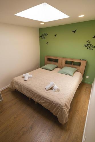 a bedroom with a large bed with towels on it at CDG • Mer de Sable • P.Asterix • Disney • Parking in Saint-Mard