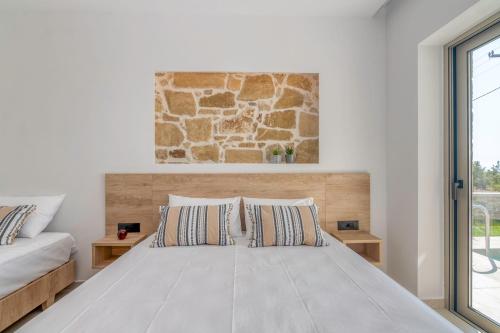 a bedroom with a bed and a stone wall at Elafonisi Pearl in Elafonisi