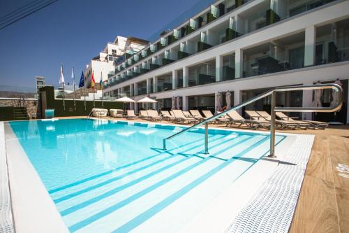 a swimming pool on the side of a building at IG Nachosol Atlantic & Yaizasol by Servatur - Adults Only in Puerto Rico de Gran Canaria