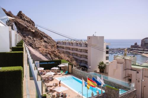 a hotel with a swimming pool next to the ocean at IG Nachosol Atlantic & Yaizasol by Servatur - Adults Only in Puerto Rico de Gran Canaria