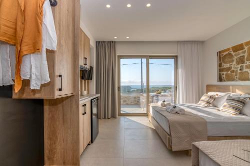 a bedroom with a large bed and a balcony at Elafonisi Pearl in Elafonisi