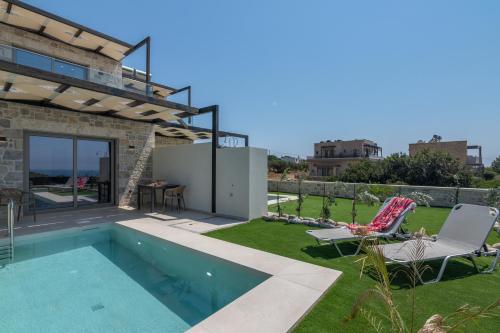 a villa with a swimming pool and a patio at Elafonisi Pearl in Elafonisi