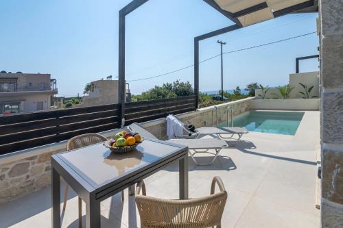 a table and chairs on a roof with a bowl of fruit at Elafonisi Pearl in Elafonisi