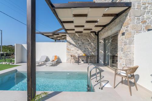 a patio with a swimming pool and a stone house at Elafonisi Pearl in Elafonisi