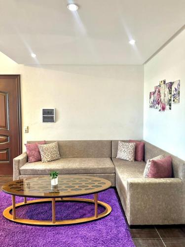 a living room with a couch and a coffee table at Luxus Apartments in Kelibia