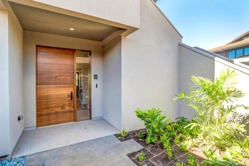 a wooden door of a house with plants at Honua Kai Luana Condos by KBM Resorts in Kaanapali