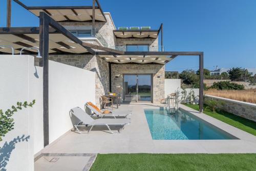 a house with a swimming pool and a patio at Elafonisi Pearl in Elafonisi