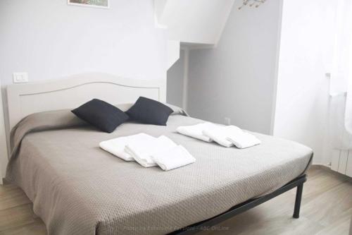a bed with two pillows on top of it at Il corso in Norcia