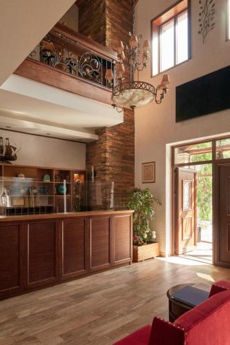 a kitchen with wooden cabinets and a red couch at Omalia Village in Áno Khóra