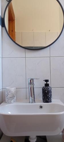 a bathroom sink with a mirror on the wall at Kepiza in Parga