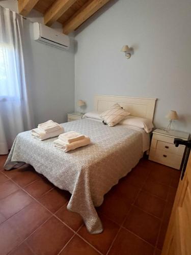 a bedroom with a bed with two towels on it at El huerto de Lino in Candeleda
