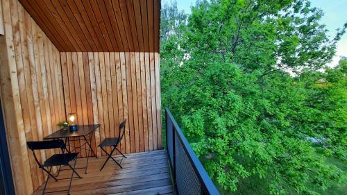 a wooden deck with a table and chairs on it at raum14 in Böbrach