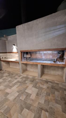 an empty room with a stone wall with benches at Cabañas Gadiel in San José de las Salinas