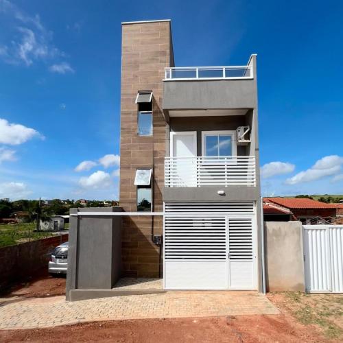 a modern house with a white garage door at Triplex Dunas - Flecheiras in Trairi