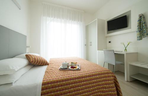 Ένα ή περισσότερα κρεβάτια σε δωμάτιο στο Hotel Pillon