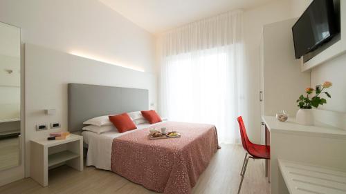 Ένα ή περισσότερα κρεβάτια σε δωμάτιο στο Hotel Pillon