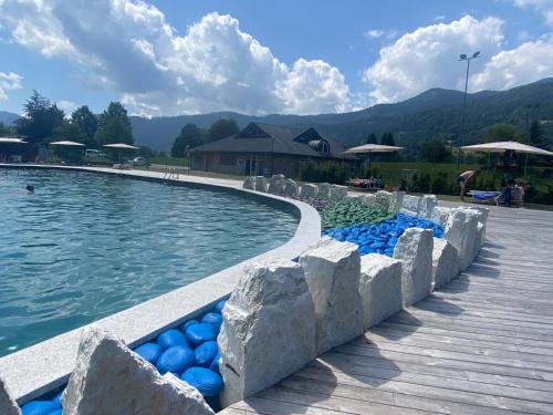 a swimming pool with blue balls in the water at Alice in Castello Tesino