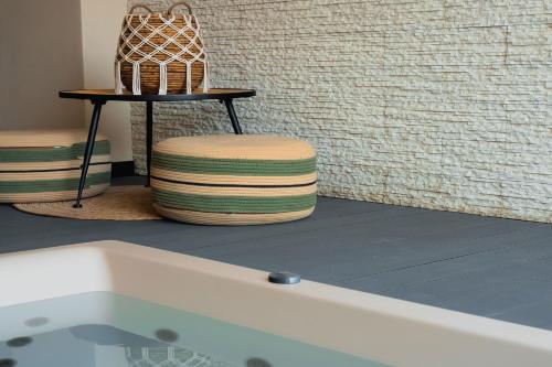 a bath tub with a stool next to a table at Kasta Beach Hotel in Ofrínion