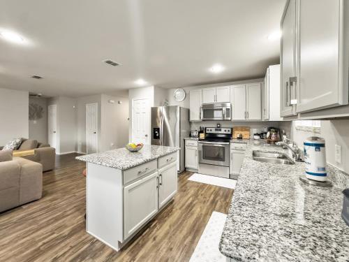 a large kitchen with white cabinets and appliances at Little Elm Getaway in Little Elm