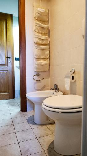 a bathroom with a toilet and a sink and towels at Casina nel Chianti in Vagliagli