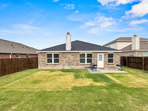 a house with a yard with a fence at Little Elm Getaway in Little Elm