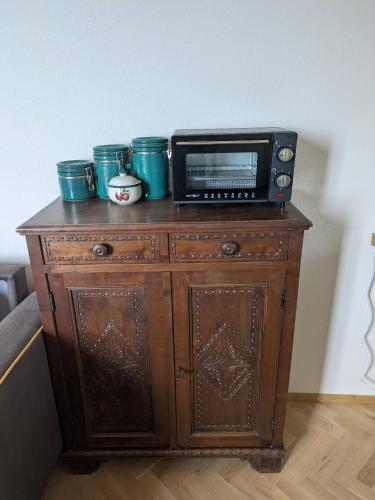 a microwave sitting on top of a wooden cabinet at Villa Smeralda - Luxury on the Italian Riviera in Lavagna