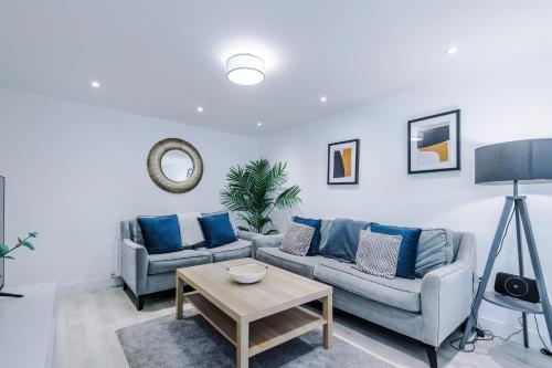 a living room with two couches and a table at The Hansas Residences - Two Elegant & Spacious Townhouses - Perfect for Business or Work Stays by Parydise Properties in Harlescott