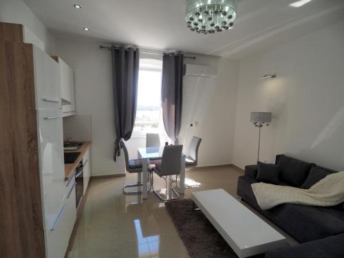 a living room with a couch and a table at Captain Emo City Apartments in Pula