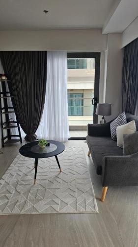 a living room with a couch and a table at Tambuli Seaside Resort 16G - Lapu Lapu in Maribago