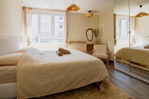a large bedroom with two beds and a window at Nuage De Lin - Charme naturel, proche gare in Saint-Nazaire