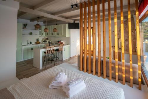 a room with a kitchen and a table with towels at The Blue Nest in Nisís Léros