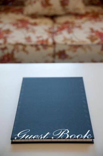 a book with the words guest book on it at Lowena Cafe and Accommodation in Hobart
