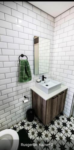 a bathroom with a sink and a mirror at Rusgerus in Pretoria