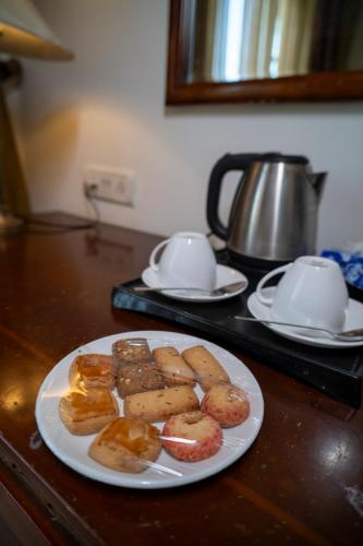 a plate of pastries on top of a counter at Hotel Merwara Estate- A Luxury Heritage Resort in Ajmer