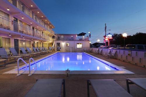 a large swimming pool in front of a hotel at Lark Motel in Stone Harbor