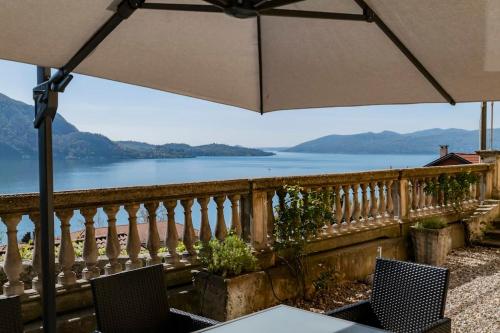 a balcony with a view of a body of water at Ghiffa villa rental in Ghiffa