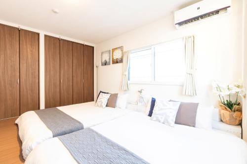 Postel nebo postele na pokoji v ubytování Sakamoto House