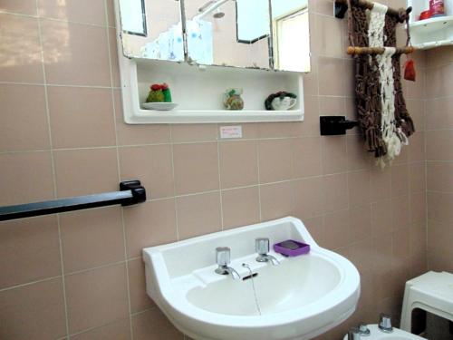 a bathroom with a sink and a mirror at Casa en Playas de Oro in Villa Carlos Paz