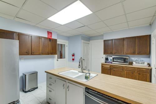 a kitchen with wooden cabinets and a sink at Less Than 1 Mi to Main St Quiet Apartment in Galesburg! in Galesburg