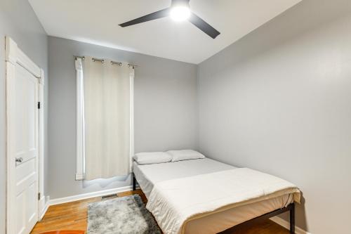 a bedroom with a bed and a ceiling fan at Less Than 1 Mi to Main St Quiet Apartment in Galesburg! in Galesburg