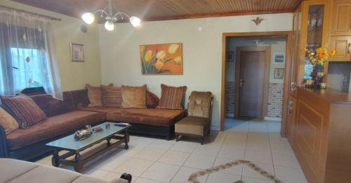 a living room with a couch and a table at Erifily's House in Nea Kalikratia