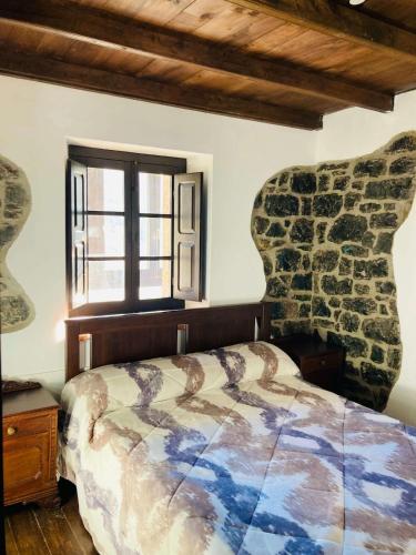 a bedroom with a bed and a window at Casa Rural Ribota! in Ribota