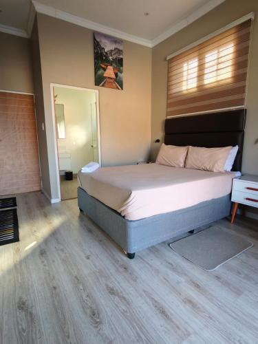 a bedroom with a large bed in a room at ARCHITECT's VIEW SUITE 1 in Durban