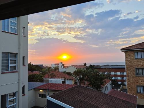 a sunset from the balcony of a building at ARCHITECT's VIEW SUITE 1 in Durban
