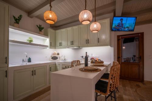 a kitchen with white cabinets and a white counter top at The Blue Nest in Nisís Léros