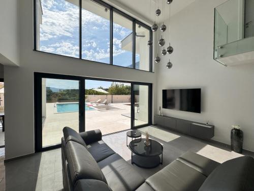 a living room with a couch and a tv at Villa Lustria in Labin