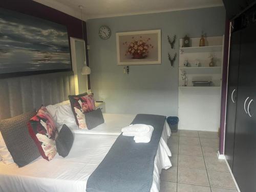 a bedroom with a bed with two towels on it at Mitchell's Guesthouse in Parow